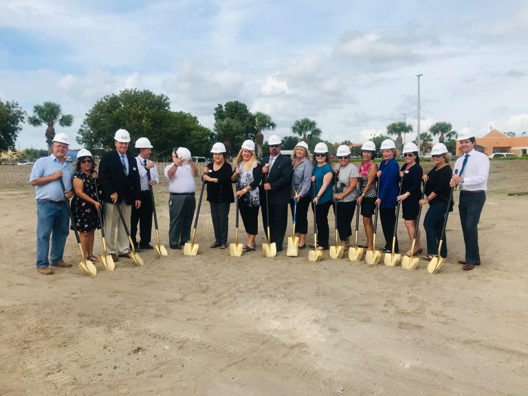 team of people in hard hats about to break ground on cape coral animal shelter new building