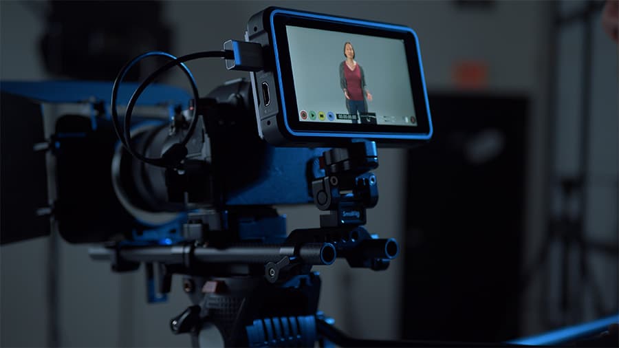 Close-up of a studio camera's viewfinder, recording an actress performing on set.