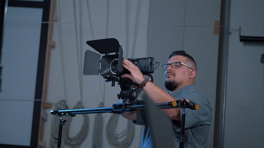 Celsius Multimedia Director Saulo Zayas operating a camera on set.