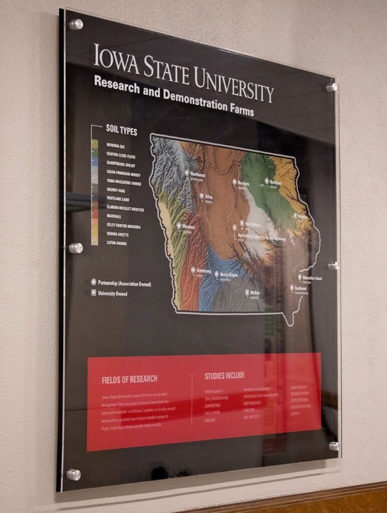 Iowa State University Research and Demonstration Farms information poster framed in the College of Agriculture and Life Sciences.