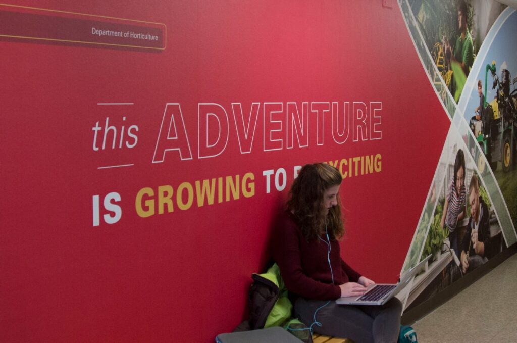Environmental design for ISU's Department of Horticulture, featuring wall graphics with photography of students and typography declaring, "This adventure is growing to be exciting."