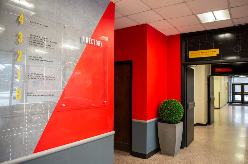 Environmental design for ISU's Department of Civil, Construction and Environmental Engineering, featuring wall graphics and acrylic standoffs with the building's directory.