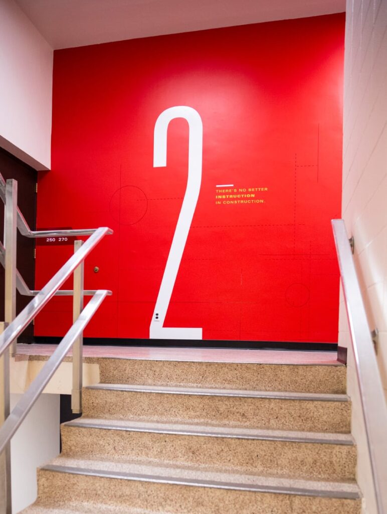 Environmental design for ISU's Department of Civil, Construction and Environmental Engineering, featuring giant wall graphics in the stairwell designating floor 2.