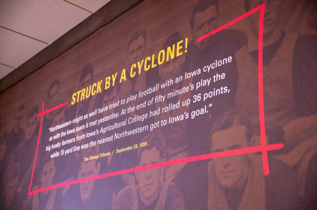 Wall graphics designed for ISU Dining's Clyde's Gastro Diner, with typography stating, "Struck by a cyclone! 'Northwester might as well have tried to play football with an Iowa cycline as the Iowa team it met yesterday. At the end of fifty minute's play the big husky farmers from Iowa's Agricultural College had rolled up 36 points, while 15 yard line was the nearest Northwestern got to Iowa's goal.' –The Chicago Tribune, September 28, 1895."