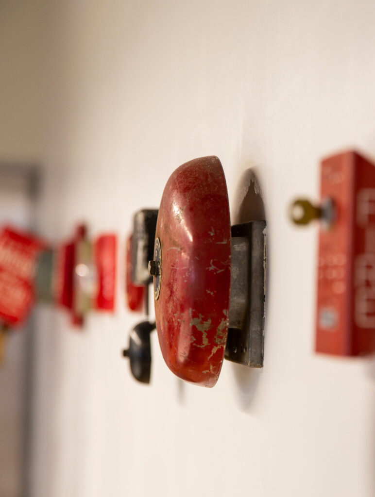 Detail of the fire alarm installation in the Flying Hippo conference room, focused on one of the older bell alarms.