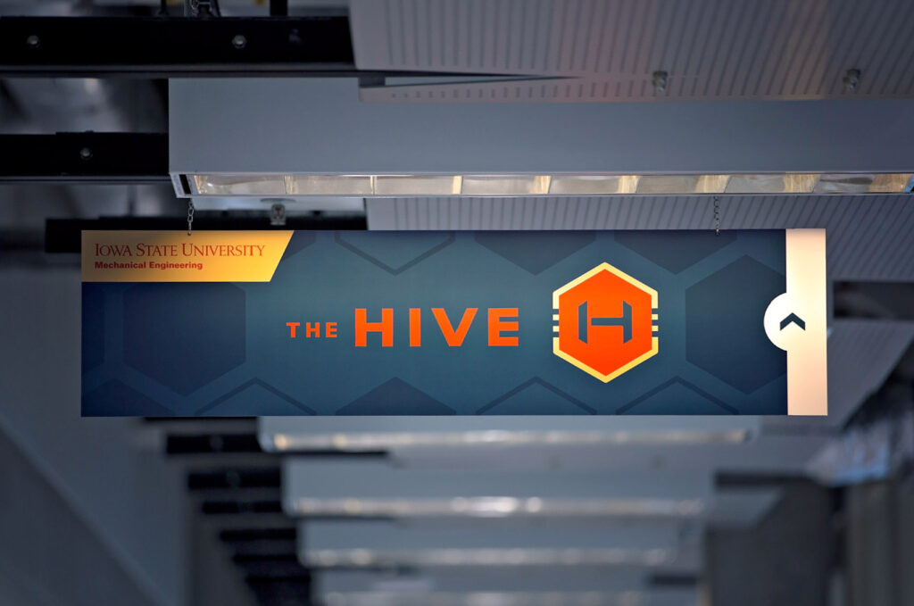 The Hive logo printed on a directional sign in ISU's Mechanical Engineering department.