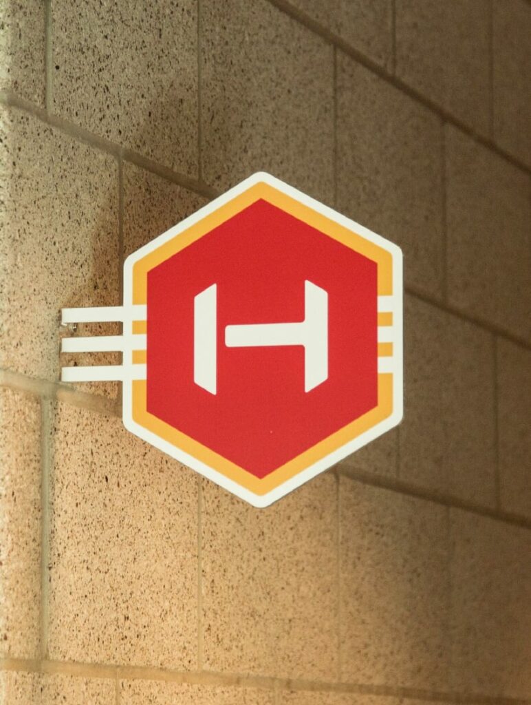 The Hive logo printed on a wall sign.