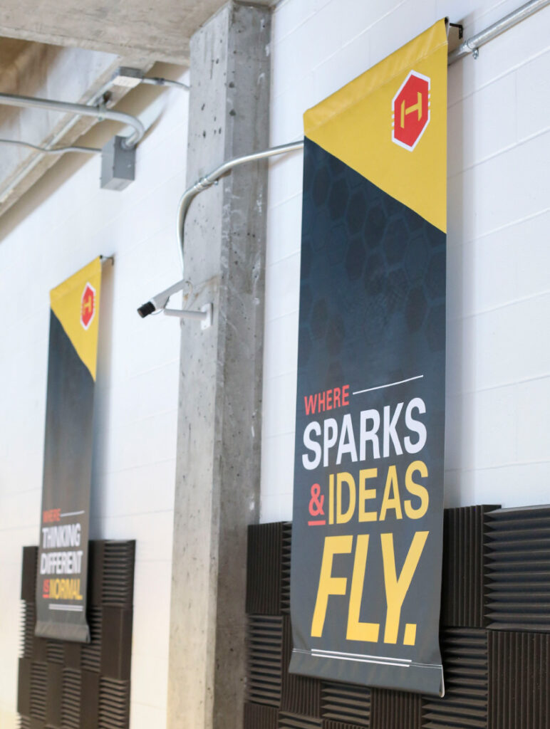Banners in The Hive declaring, "Where sparks and ideas fly," and "Where thinking different is normal."