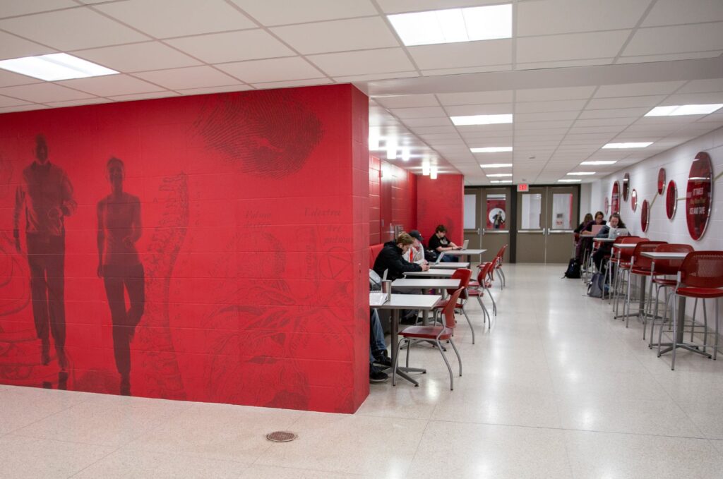 Environmental design for ISU's Department of Kinesiology, featuring floor-to-ceiling wall graphics and 3D art.