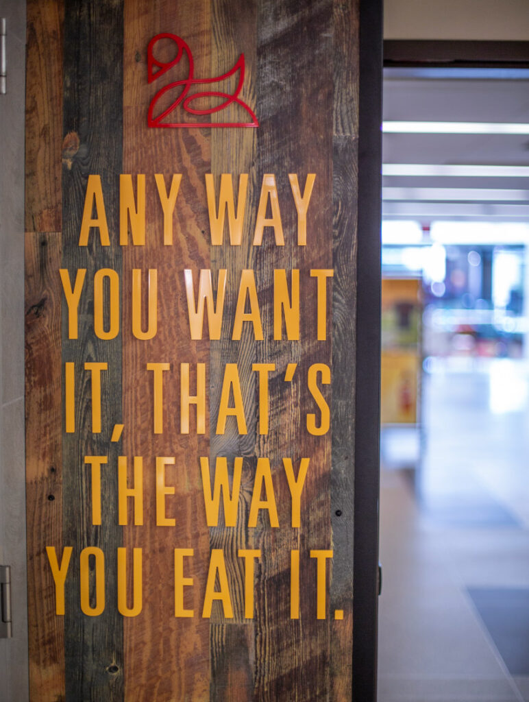 3D lettering detail at Lance and Ellie's Delicatessen, declaring, "Any way you want it, that's the way you eat it."