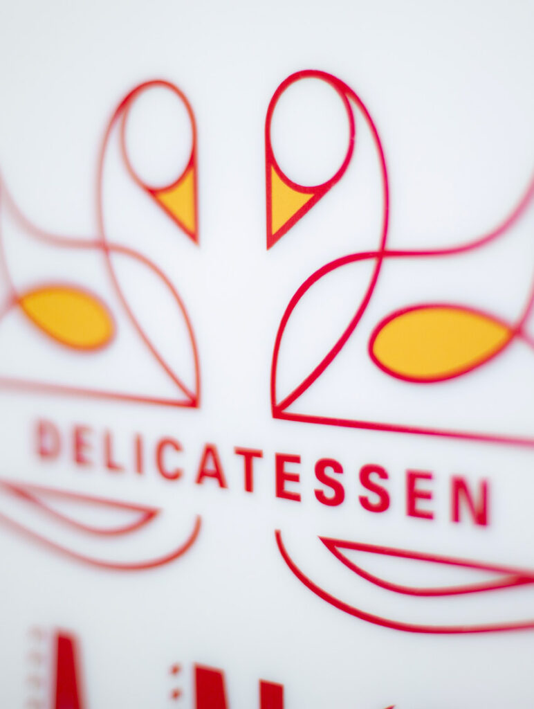 Detail of the Lance and Ellie's Delicatessen logo printed on a sign.