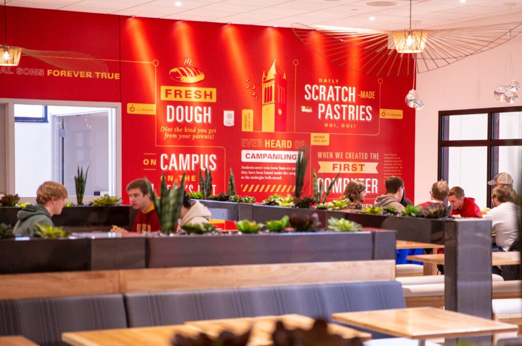 Environmental design for ISU's The Mezzanine, where students can sit and eat lunch. The walls are covered in intricate graphics featuring fun facts about the campus and ISU Dining.