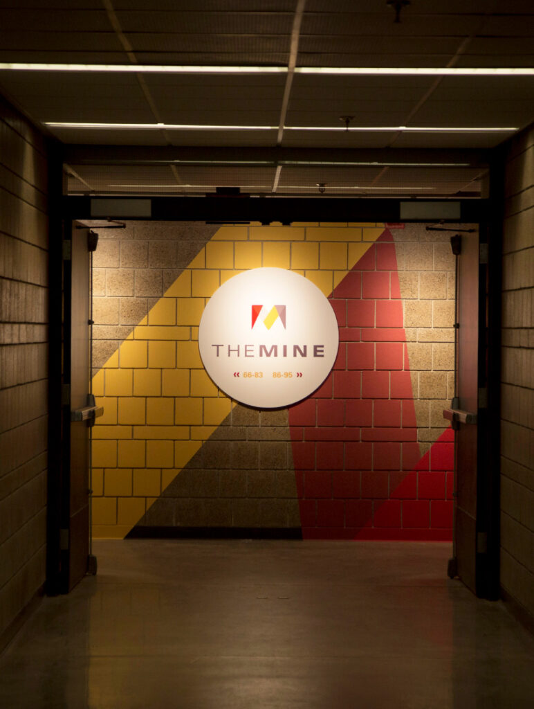The Mine logo on directional signage in ISU's Department of Mechanical Engineering's basement.