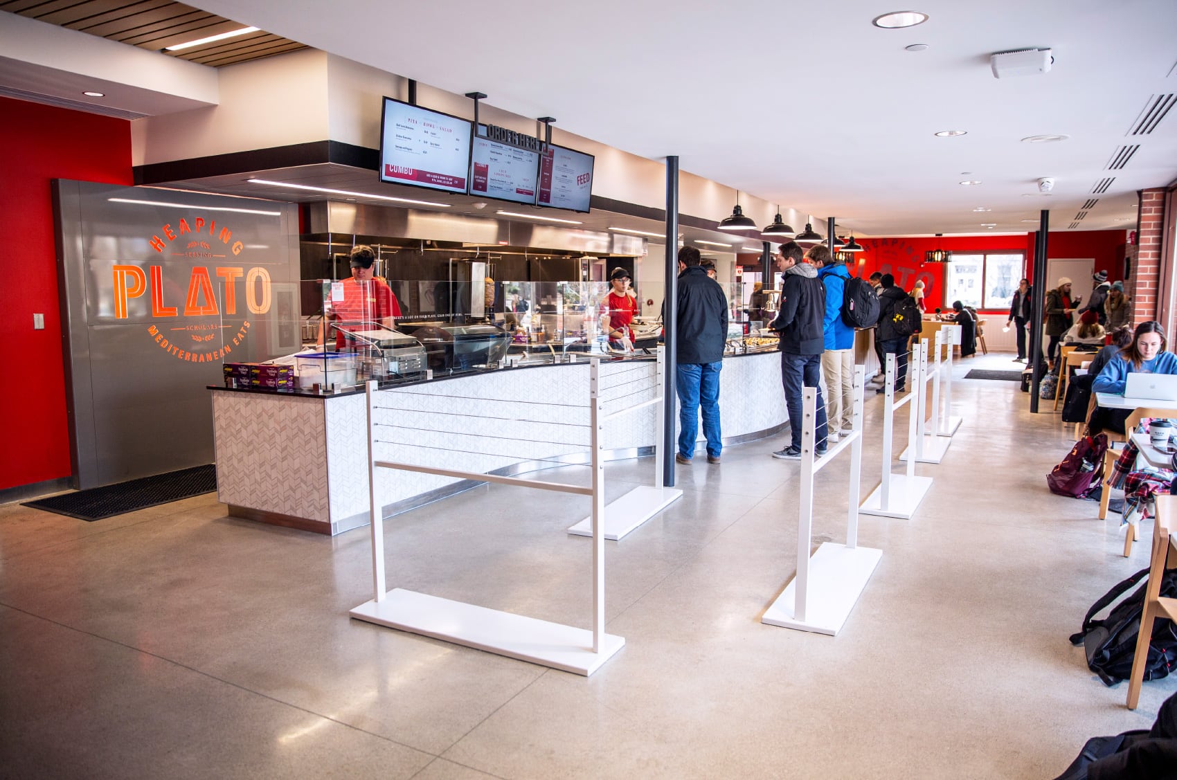 Restaurant design for ISU Dining's Heaping Plato, featuring the logo printed on the wall behind the cashier.