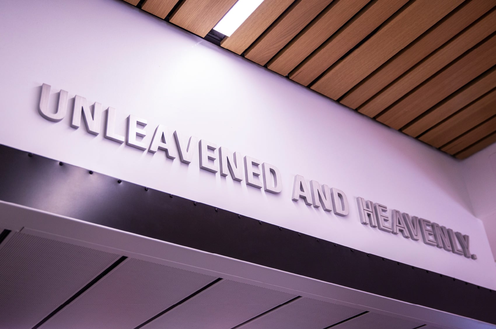 3D letters over the Heaping Plato restaurant declaring, "Unleavened and heavenly."