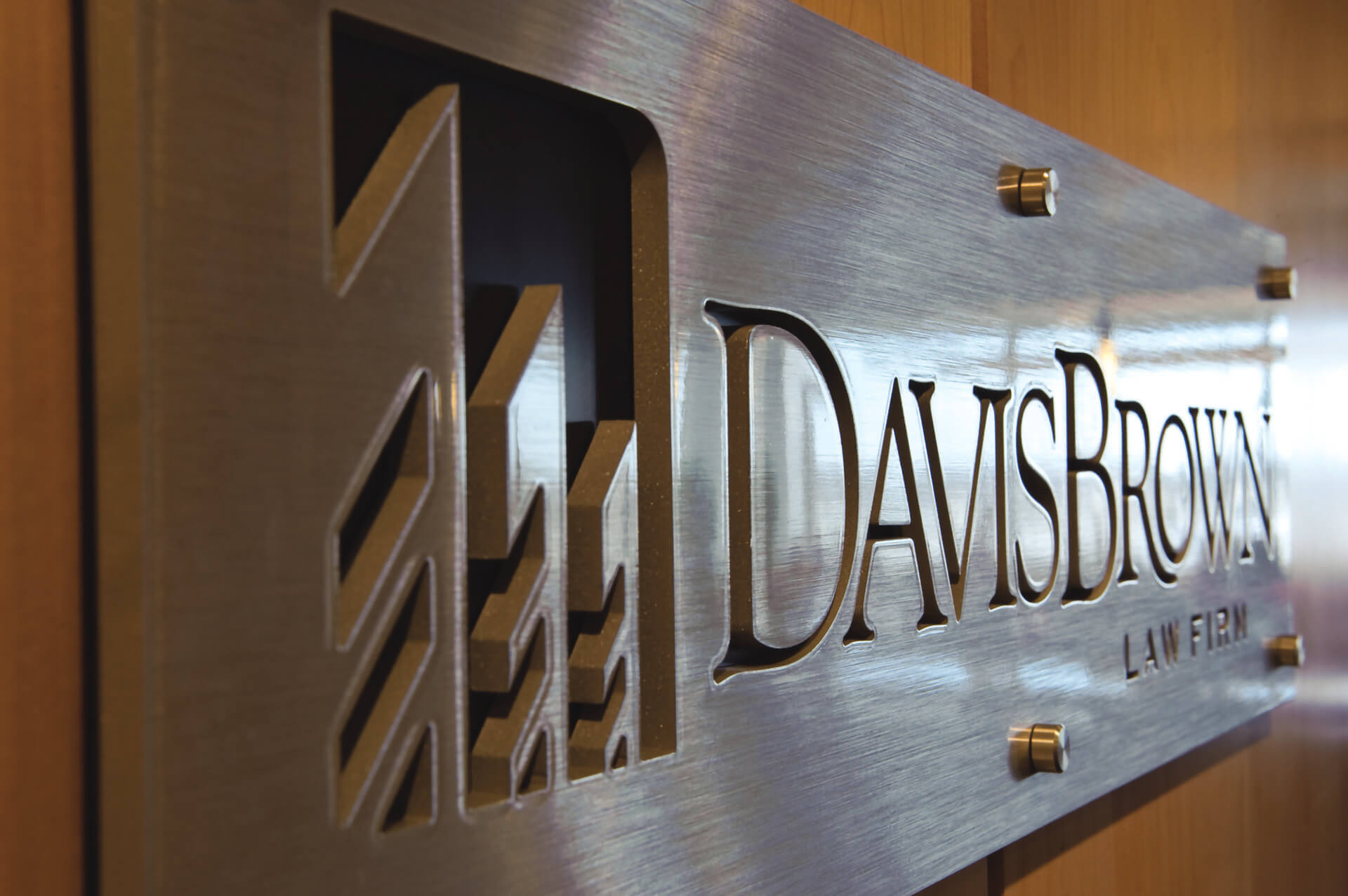 Bronze metal plaque with 3D laser cutting for Davis Brown Law Firm, mounted to a door.