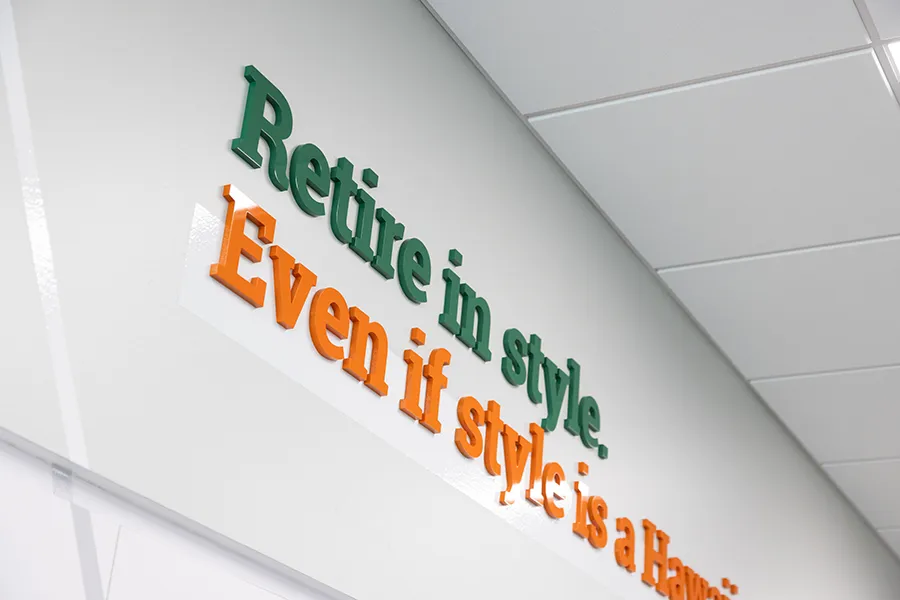 Detail of the 3D acrylic lettering at Farmer's State Bank, featuring the tagline, "Retire in style. Even if style is a Hawaiian shirt and flip flops."