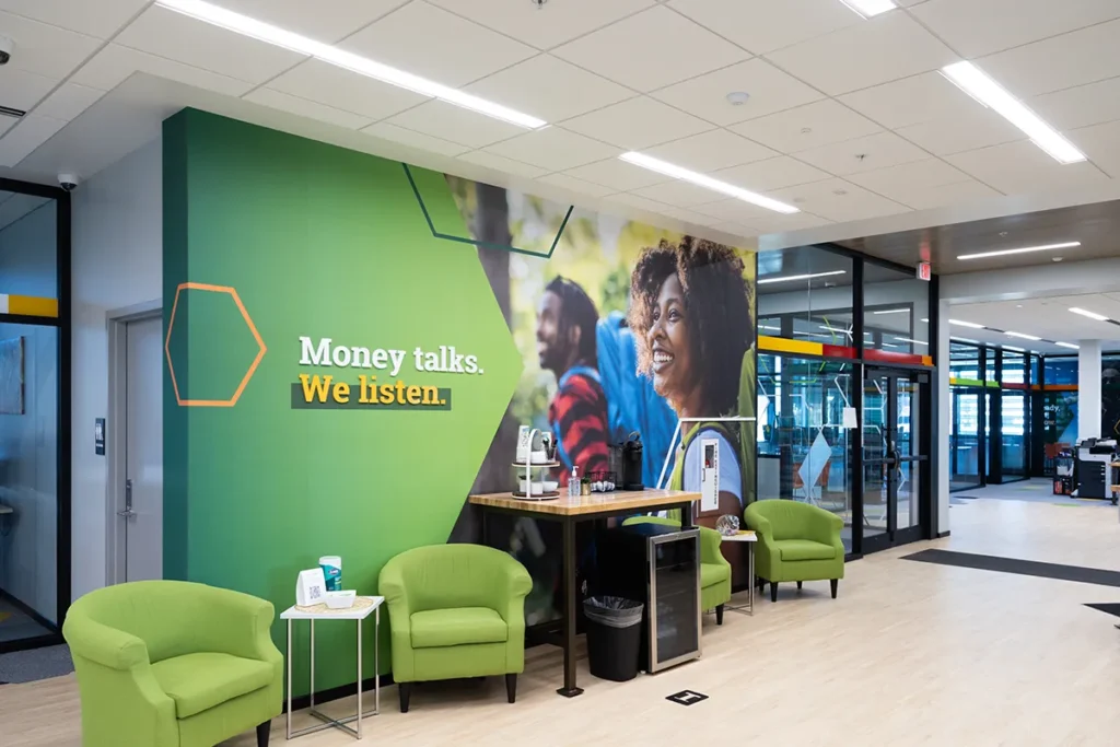 Farmer's State Bank lobby with branded green chairs for guests, featuring wall decals with the tagline, "Money talks, we listen."