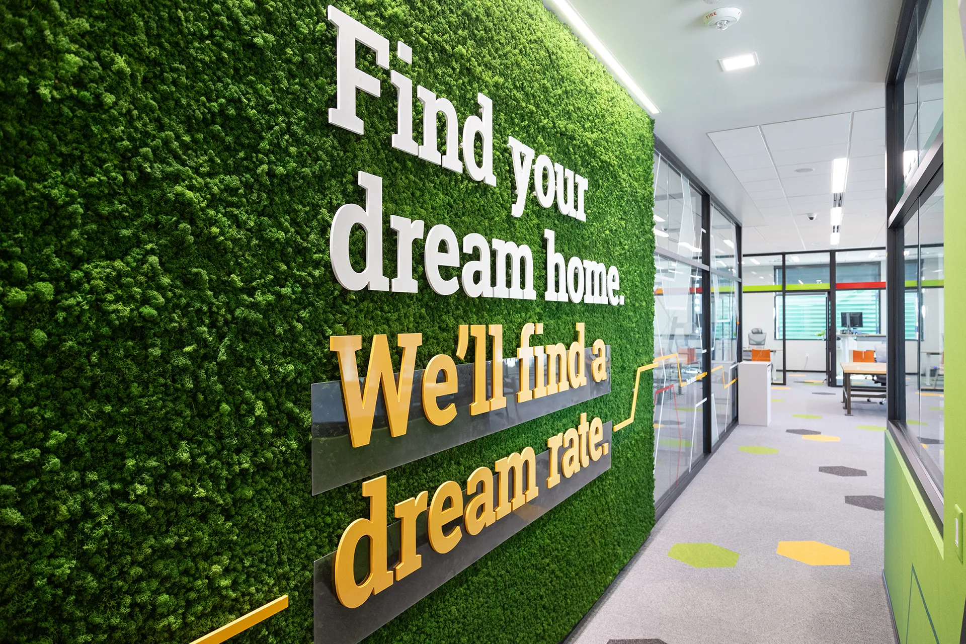 Moss wall installation at Farmer's State Bank's Des Moines branch office, featuring the tagline, "Find your dream home. We'll find a dream rate," in 3D acrylic letters.