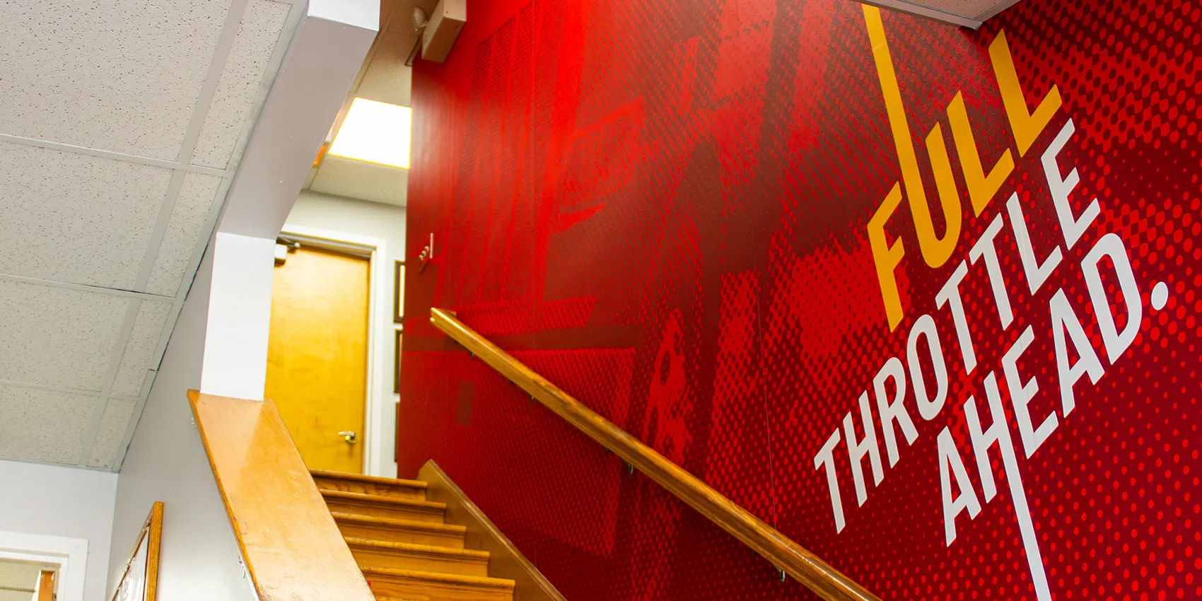 wall lettering with brand messaging along a staircase