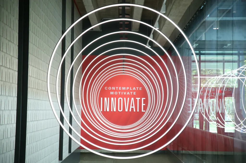 light rings in front of a red wall at Iowa State University Campus