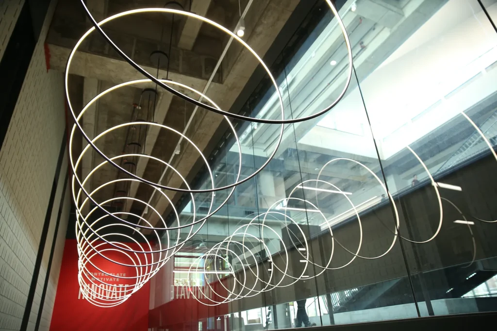 light rings in front of a red wall at Iowa State University Campus